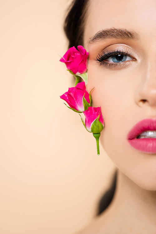 cropped view of sensual young woman with flowers on face  isolated on pink