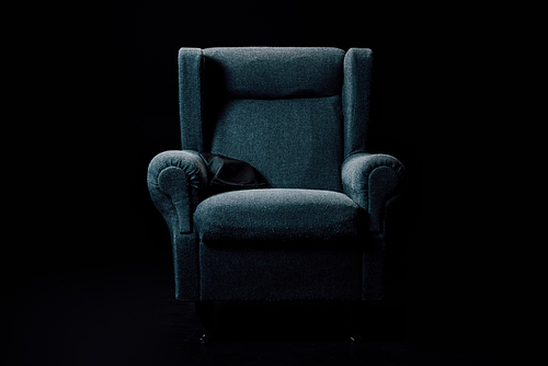 grey, soft armchair isolated on black with lightening