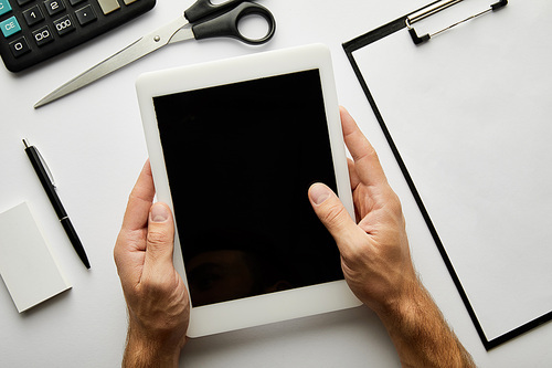 cropped view of man holding digital tablet with copy space