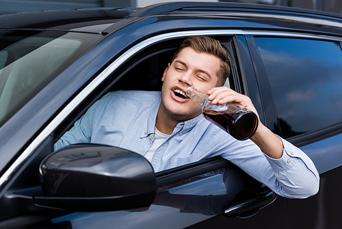 drunk man drinking whiskey while looking out car window