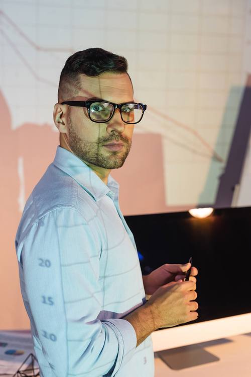 businessman in glasses holding pen and 