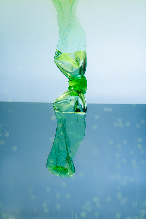 used plastic bottle underwater, ecology concept