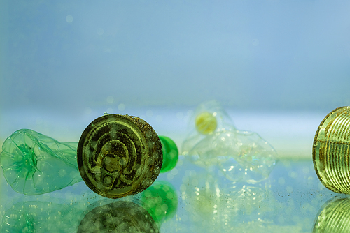 rusty tins and plastic bottles underwater, ecology concept