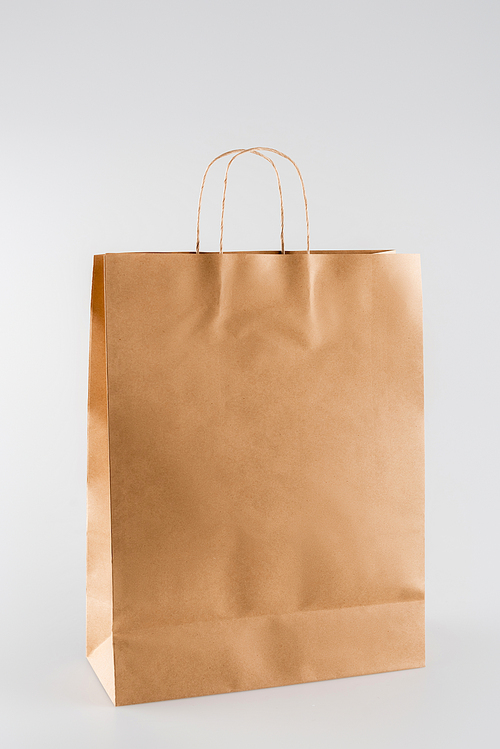 shopping bag made of paper on grey, ecology concept