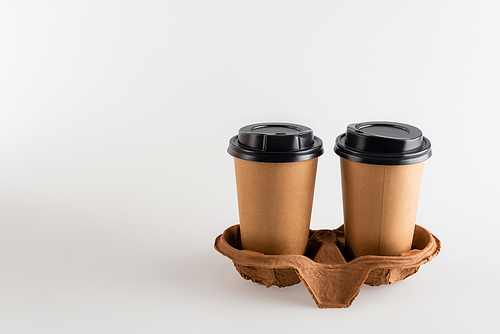 coffee to go in paper cups on grey, ecology concept