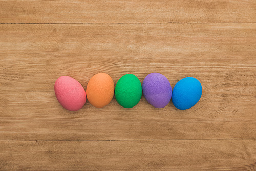 top view of  painted easter eggs on wooden table