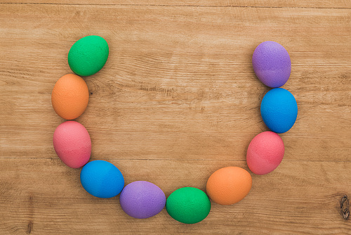 top view of  painted easter eggs on wooden table