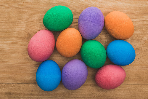 top view of  painted easter eggs on wooden table