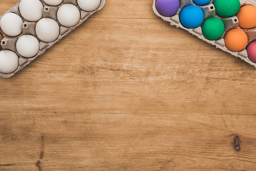 top view of  painted easter eggs on wooden table