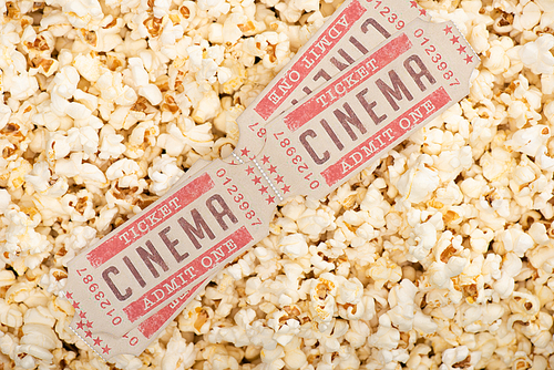 top view of cinema tickets on airy crispy popcorn