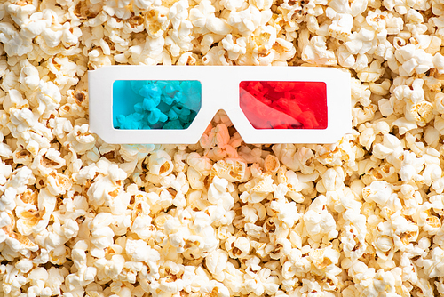 top view of 3d glasses on crunchy popcorn, cinema concept
