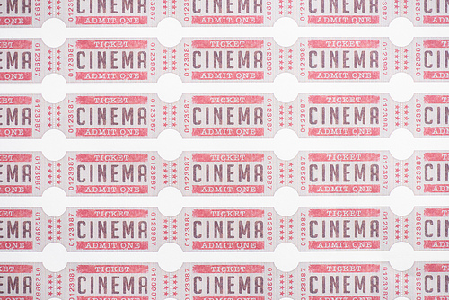 background from rows of cinema tickets on white, top view