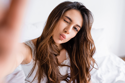 Brunette woman with face expression  in bedroom