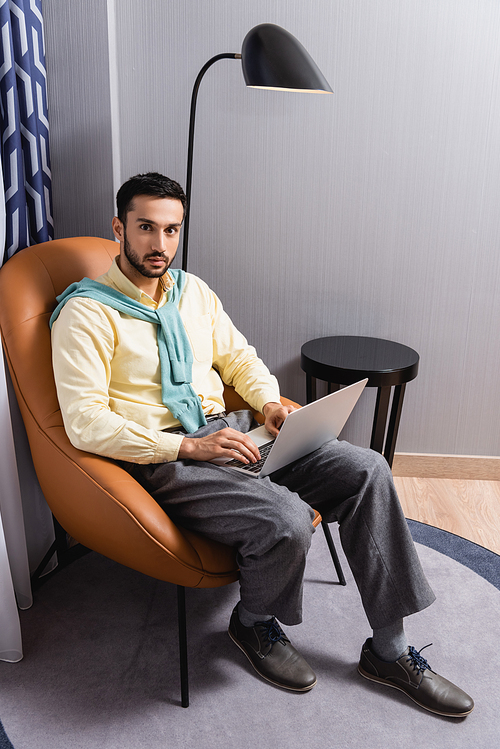 Arabian man  while using laptop in hotel
