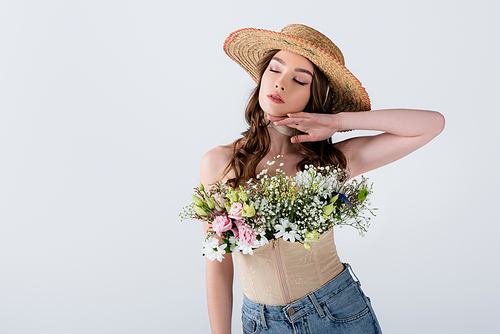 Woman in straw hat and blouse with flowers isolated on grey