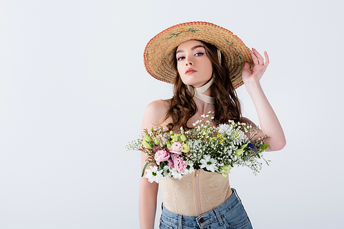 Stylish woman in straw hat with flowers  isolated on grey