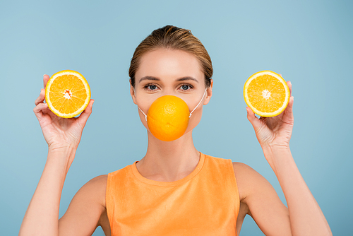 young woman in protection mask made of orange  isolated on blue