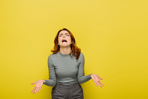 frustrated woman whining and gesturing isolated on yellow