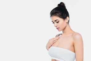 Brunette woman in white bra looking away isolated on white