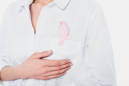 Ribbon of breast cancer awareness on shirt of young woman isolated on white