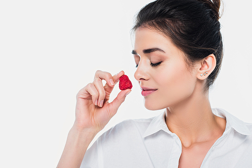 Young woman with closed eyes holding strawberry isolated on white