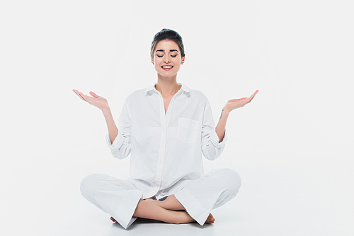 Smiling woman practicing yoga on white background