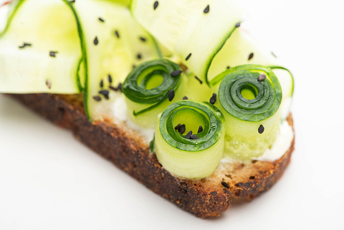 close up view of fresh cucumber toast with seeds on white background