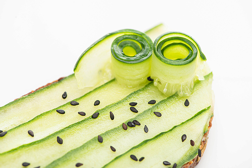 close up view of fresh cucumber toast with seeds isolated on white