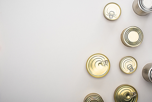 top view of cans with canned food on white background, food donation concept