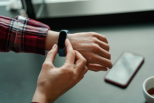 cropped view of woman touching smart watch