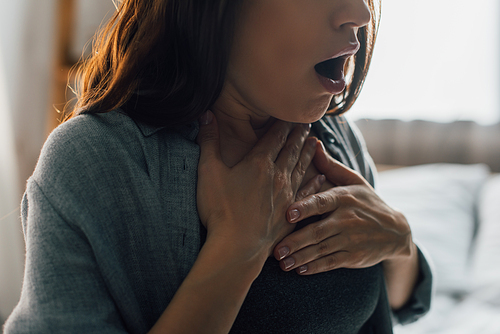 cropped view of brunette woman having panic attack at home