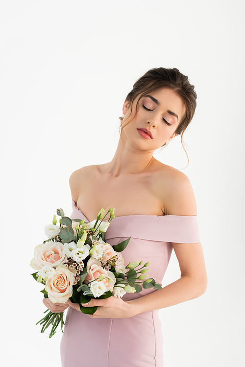 sensual woman in dress, with naked shoulders, holding wedding bouquet isolated on white