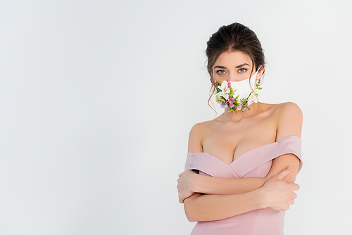 woman in pink dress and medical mask with flowers posing isolated on grey