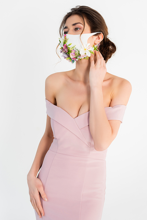 woman in elegant dress and medical mask with floral decor posing isolated on grey