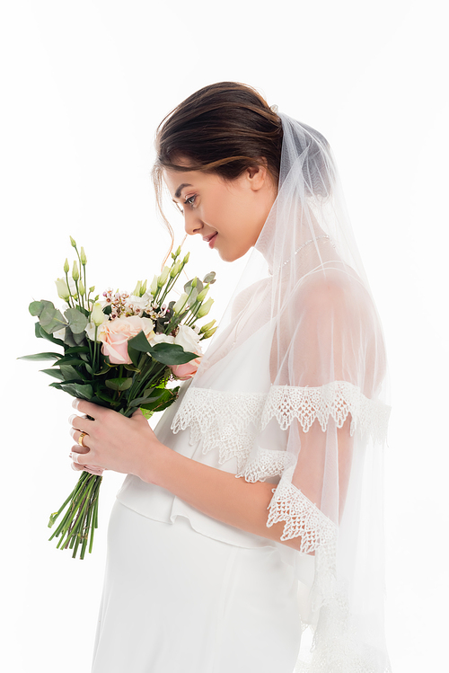 side view of pregnant bride holding wedding bouquet isolated on white