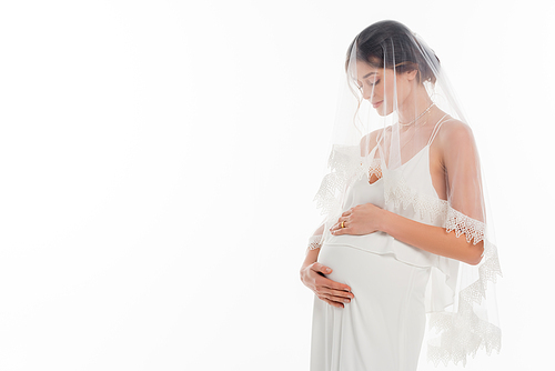 pregnant woman in wedding dress and veil touching tummy isolated on white
