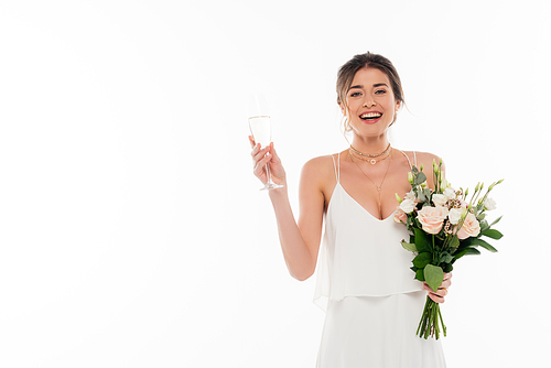 joyful bride holding wedding bouquet and champagne glass isolated on white