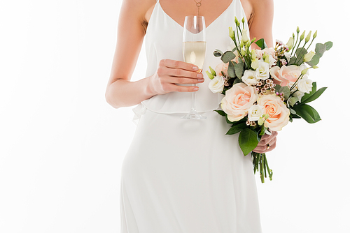 cropped view of fiancee holding champagne and wedding bouquet isolated on white