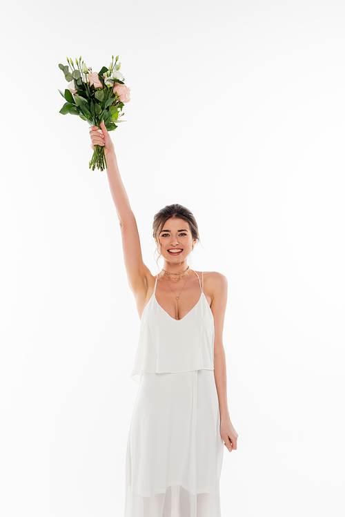 cheerful bride holding wedding bouquet in raised hand isolated on white