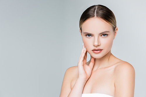 pretty young woman with makeup  isolated on grey