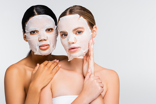 interracial women in moisturizing sheet masks isolated on white