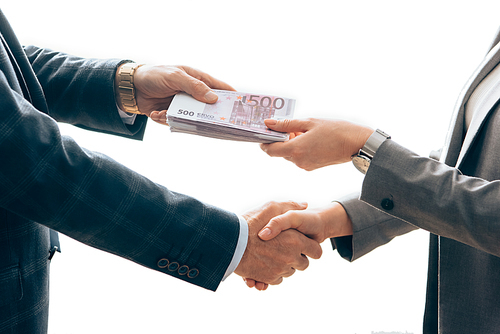 Cropped view of investor giving money and handshaking with businesswoman isolated on white