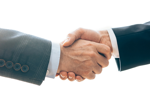 Cropped view of businessmen shaking hands isolated on white