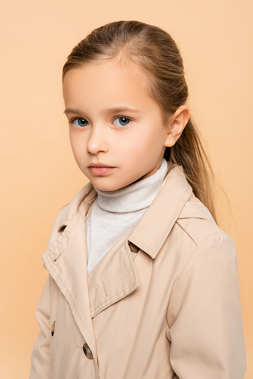 kid in trench coat  isolated on beige