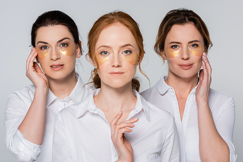 Women in white shirts and eye patches  isolated on grey