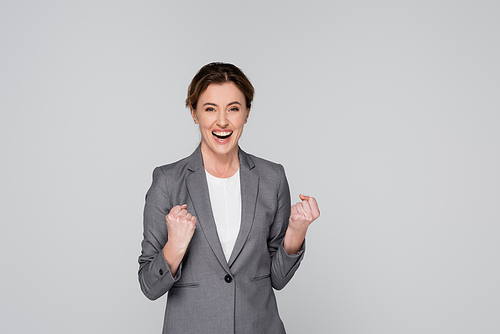 Successful businesswoman showing yes gesture isolated on grey