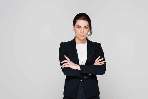 Brunette businesswoman with crossed arms  isolated on grey