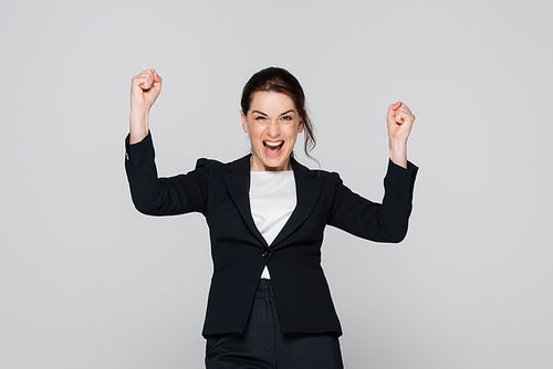 Excited manager showing yes gesture isolated on grey