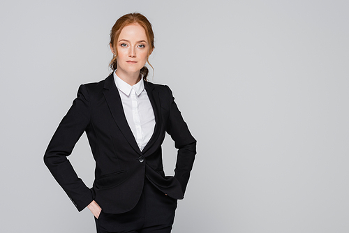 Redhead manager in suit  isolated on grey