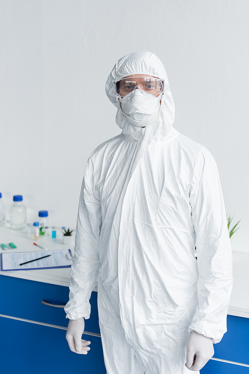 Scientist in hazmat suit and goggles  in laboratory
